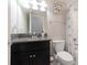 Bathroom with dark vanity, granite countertop, and shower/tub combo at 10038 Corso Milano Dr, Tampa, FL 33625