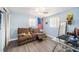 Bedroom with reclining sofa, glass-top desk, and ceiling fan at 4424 Beacon Square Dr, Holiday, FL 34691