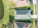 Aerial view of house and backyard, showcasing a fenced-in yard and a pond at 1810 Raven Glen Dr, Ruskin, FL 33570