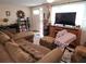 Comfortable living room with brown sectional sofa and large TV at 10802 Hale St, Port Richey, FL 34668