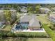 Expansive backyard with screened pool and patio furniture, complemented by lush landscaping at 14173 Pullman Dr, Spring Hill, FL 34609