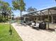 Spacious backyard with a screened-in patio and outdoor furniture for relaxing and enjoying the outdoor living space at 14173 Pullman Dr, Spring Hill, FL 34609