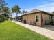 Landscaped backyard with a walkway leading to the pool area at 14173 Pullman Dr, Spring Hill, FL 34609