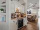 Stylish bar area featuring custom cabinetry, granite countertops, and a wine refrigerator at 14173 Pullman Dr, Spring Hill, FL 34609