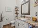 Bathroom features a framed mirror, granite counters, and storage shelving at 14173 Pullman Dr, Spring Hill, FL 34609
