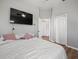 Comfortable bedroom featuring a large TV, ceiling fan, and access to a walk-in closet and additional storage space at 14173 Pullman Dr, Spring Hill, FL 34609