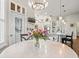 Open-concept dining area features a view into the kitchen with a chandelier at 14173 Pullman Dr, Spring Hill, FL 34609