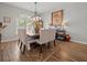 Dining room showcasing elegant furnishings, a decorative light fixture, and wood-look tile floors at 14173 Pullman Dr, Spring Hill, FL 34609