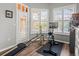 Well-lit exercise room features fitness equipment, wood floors, and backyard views at 14173 Pullman Dr, Spring Hill, FL 34609