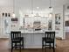 White kitchen island with bar seating, granite countertop, and stylish pendant lighting at 14173 Pullman Dr, Spring Hill, FL 34609