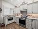Charming kitchen with stainless steel appliances, granite countertops and white cabinets at 14173 Pullman Dr, Spring Hill, FL 34609