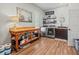 Functional laundry room with stainless steel appliances, wood floors, and work table at 14173 Pullman Dr, Spring Hill, FL 34609