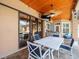Covered patio featuring a ceiling fan, outdoor television, and comfortable seating, perfect for outdoor relaxation and entertainment at 14173 Pullman Dr, Spring Hill, FL 34609