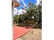 A spacious backyard features a red painted patio area perfect for outdoor gatherings at 36822 Kay Ave, Zephyrhills, FL 33542