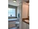 Bright bathroom featuring a soaking tub with a large window and ample storage at 36822 Kay Ave, Zephyrhills, FL 33542