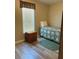 Cozy bedroom with a comfortable single bed and natural light from the window at 36822 Kay Ave, Zephyrhills, FL 33542