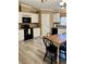 Charming kitchen featuring white cabinetry, black appliances, and a cozy dining area with a wooden table at 36822 Kay Ave, Zephyrhills, FL 33542