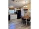 Charming kitchen featuring white cabinetry, black appliances, and a cozy dining area with a wooden table at 36822 Kay Ave, Zephyrhills, FL 33542