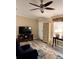 Cozy living room featuring wood-look floors, a large television, and a plush recliner at 36822 Kay Ave, Zephyrhills, FL 33542