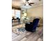 Inviting living room with wood-look flooring and a floral area rug creating a cozy atmosphere at 36822 Kay Ave, Zephyrhills, FL 33542