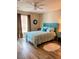 Comfortable bedroom with a bright blue bed frame and stylish blue accents, and wood look floors at 36822 Kay Ave, Zephyrhills, FL 33542