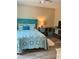 Comfortable bedroom with a bright blue bed frame and stylish blue accents, and wood look floors at 36822 Kay Ave, Zephyrhills, FL 33542