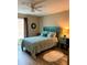Comfortable bedroom with a bright blue bed frame and stylish blue accents, and wood look floors at 36822 Kay Ave, Zephyrhills, FL 33542