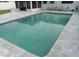 Inviting rectangular swimming pool with light gray tile deck at 4310 Huntington Ne St, St Petersburg, FL 33703