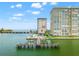 Stunning aerial view of waterfront condos with a pool, boat dock, and bridge access at 5200 Brittany S Dr # 1202, St Petersburg, FL 33715