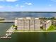 Aerial view shows a waterfront condominium community featuring a dock, pool and bay views at 5200 Brittany S Dr # 1202, St Petersburg, FL 33715