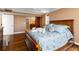 Spacious bedroom featuring hardwood floors and a view of the bathroom and a plush bed with floral patterned linens at 5200 Brittany S Dr # 1202, St Petersburg, FL 33715