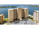 A high-rise condo building features an expansive parking lot and lush, tropical landscaping at 5200 Brittany S Dr # 1202, St Petersburg, FL 33715