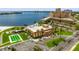 A waterfront condominium complex with a pool, parking, lush landscaping, and a view of the bay at 5200 Brittany S Dr # 1202, St Petersburg, FL 33715