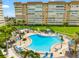 Beautiful community pool area with lounge chairs, tables, and lush tropical landscaping at 5200 Brittany S Dr # 1202, St Petersburg, FL 33715