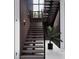 Modern staircase with dark wood treads and a glass railing at 1076 Snell Isle Ne Blvd, St Petersburg, FL 33704