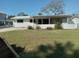 Single story home with covered patio and well-maintained lawn at 4310 Huntington Ne St, St Petersburg, FL 33703