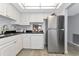 Kitchen with stainless steel refrigerator and white cabinets at 1540 Glen Oaks E Dr # B134, Sarasota, FL 34232