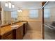 Bathroom with double sinks, granite countertop and a shower at 5200 Brittany S Dr # 1202, St Petersburg, FL 33715