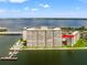 Aerial view of a waterfront high-rise building with a pool and marina at 5200 Brittany S Dr # 1202, St Petersburg, FL 33715
