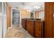 Bathroom with double sinks, granite countertop, and a walk-in shower at 5200 Brittany S Dr # 1202, St Petersburg, FL 33715