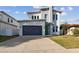 Modern two-story house with green door and gray exterior at 3119 W Cypress St, Tampa, FL 33607