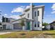 Modern two-story house with green door and gray exterior at 3119 W Cypress St, Tampa, FL 33607