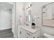 Modern bathroom with white cabinets, marble countertops, and a walk-in shower at 3119 W Cypress St, Tampa, FL 33607