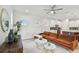 Open living room with sectional sofa and marble-top coffee table at 3119 W Cypress St, Tampa, FL 33607