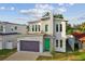 Modern two-story house with a green door and attached garage at 3119 W Cypress St, Tampa, FL 33607