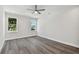 Spacious bedroom with hardwood floors and two large windows at 3119 W Cypress St, Tampa, FL 33607