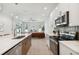 Modern kitchen with island, stainless steel appliances, and white cabinetry at 3119 W Cypress St, Tampa, FL 33607