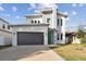 Modern two-story house with green door and gray exterior at 3119 W Cypress St, Tampa, FL 33607