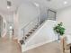 Modern staircase with sleek metal railing and tile flooring at 3119 W Cypress St, Tampa, FL 33607