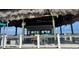 Overwater beach bar with thatched roof at 12904 College Hill Dr, Hudson, FL 34667